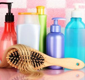 comb-brush-with-hair-cosmetic-bottles-bathroom_392895-356261